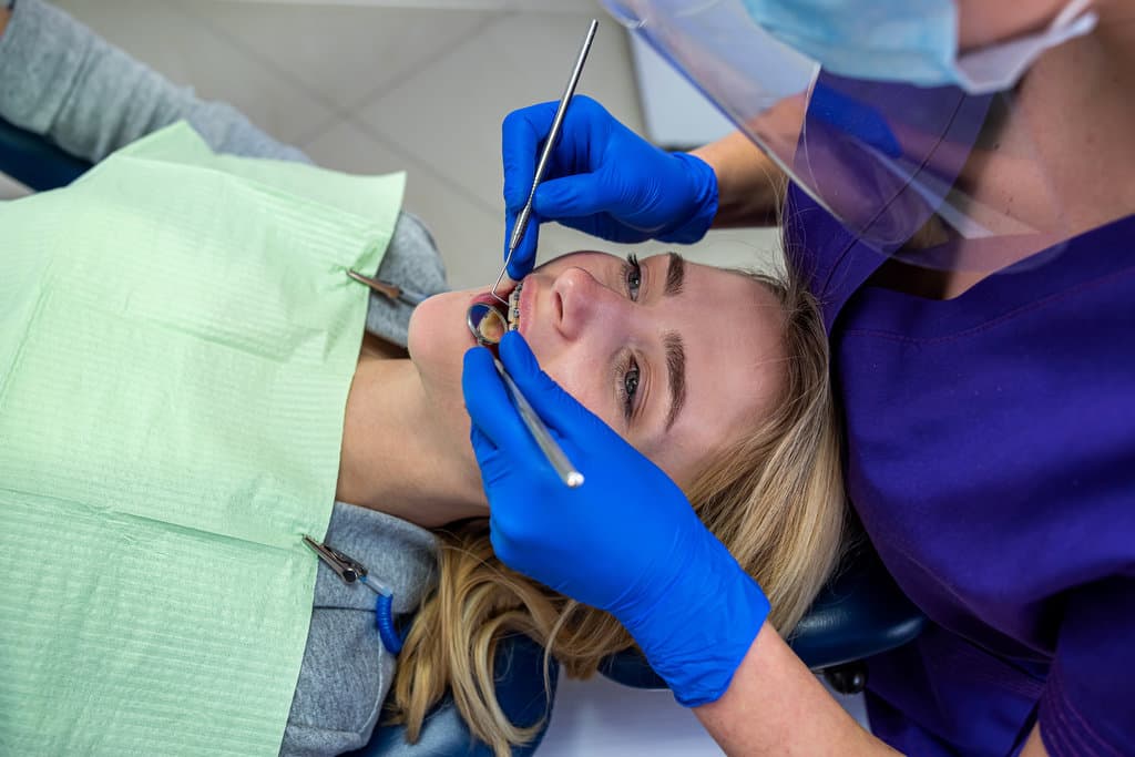 client comes to the dentist to whiten and grind the brushing routine at her woman's dentist.