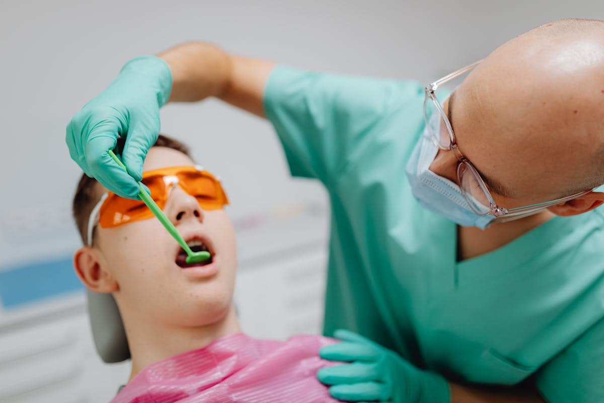A Dentist Looking at the Patient's Teeth.jpg