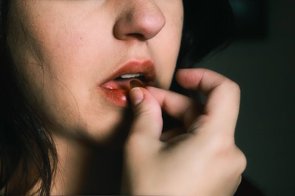 Woman With Red Lipstick Holding Red Pill