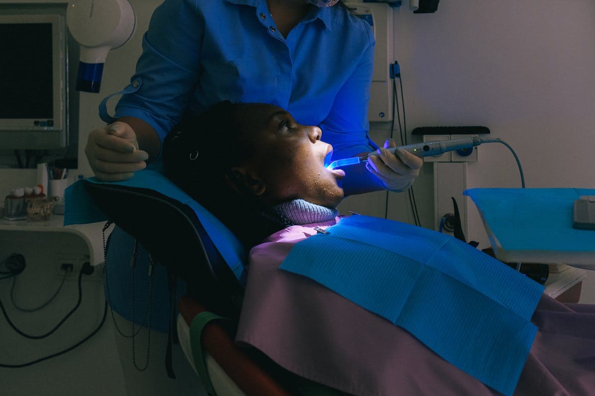 Dentist uses modern equipment for dental treatment on a patient