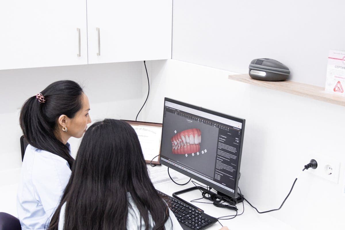 Dentists Looking at Teeth Model on the Computer