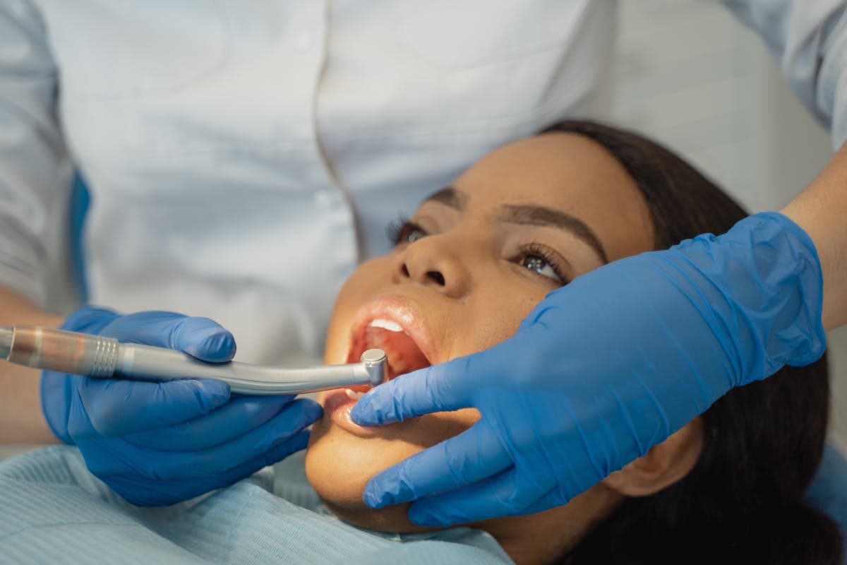 Dentist using Dental Grinder on a Patient