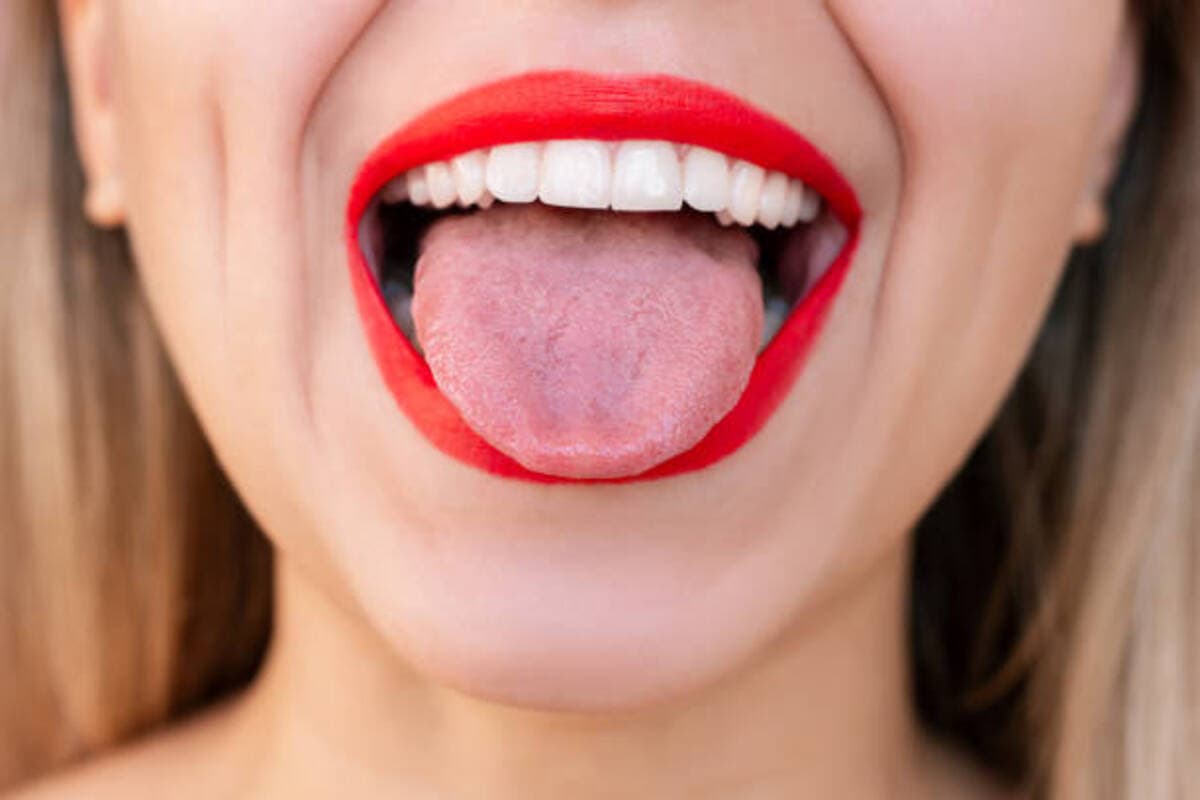 Young Blonde Woman Sticking Out Tongue With Her Mouth