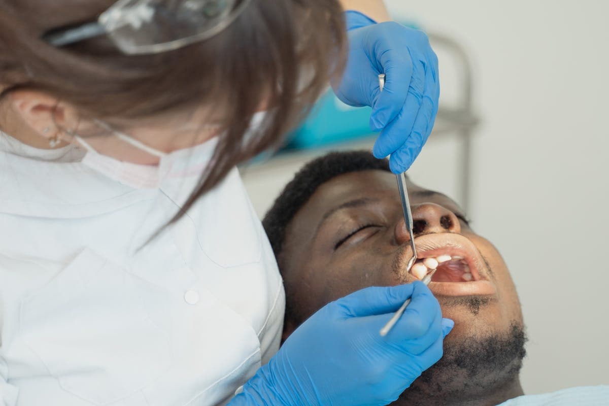 A Dentist Treating a Male Patient