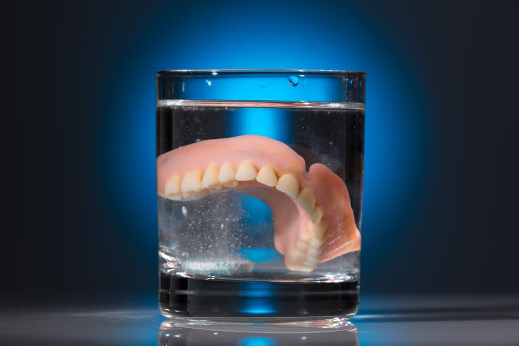 dentures in a water glass