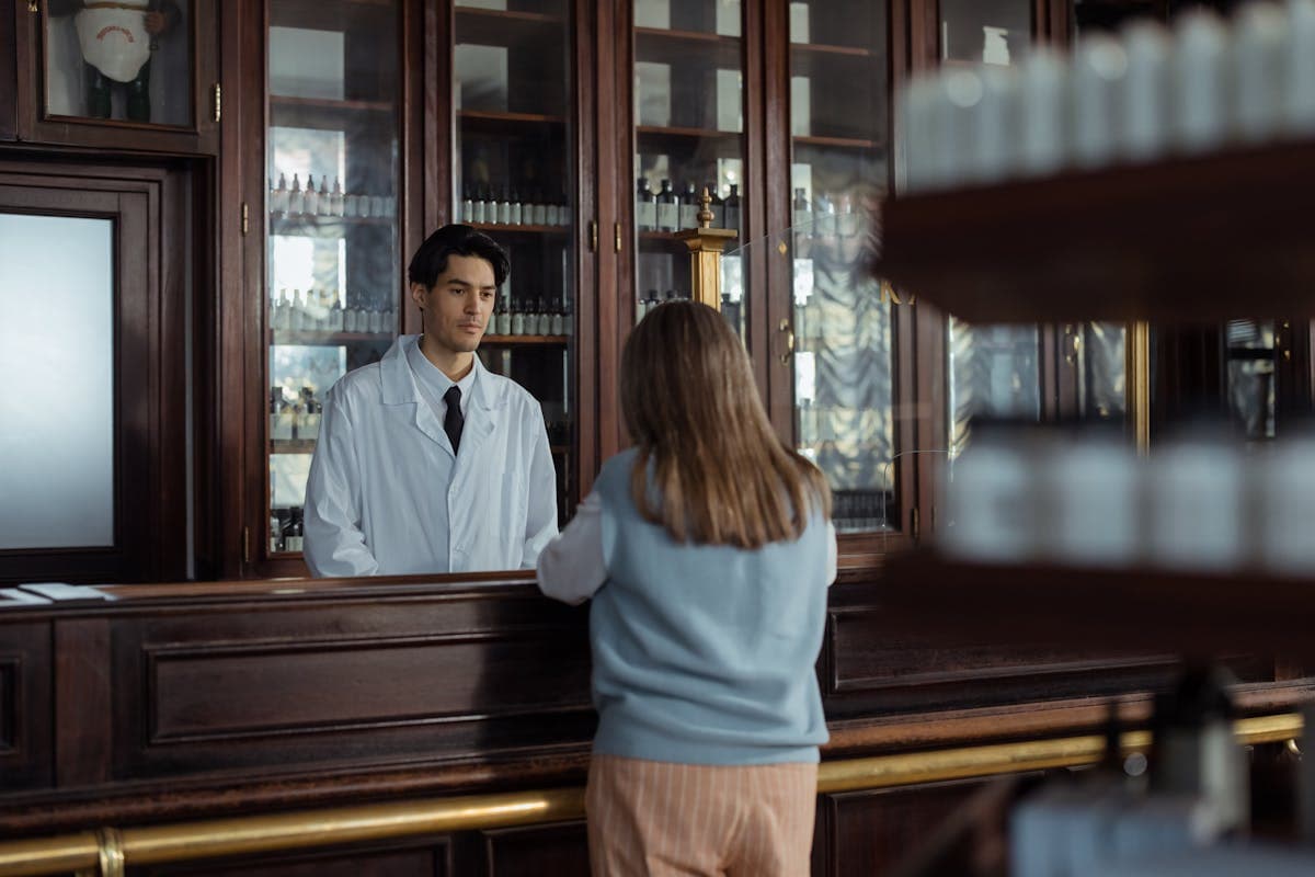 Back View of Person Standing near the Wooden Counter.jpg